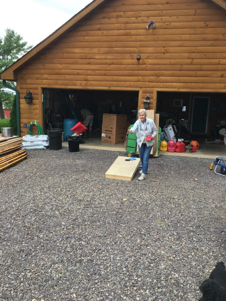 Grammy whipping up on the kids in corn hole