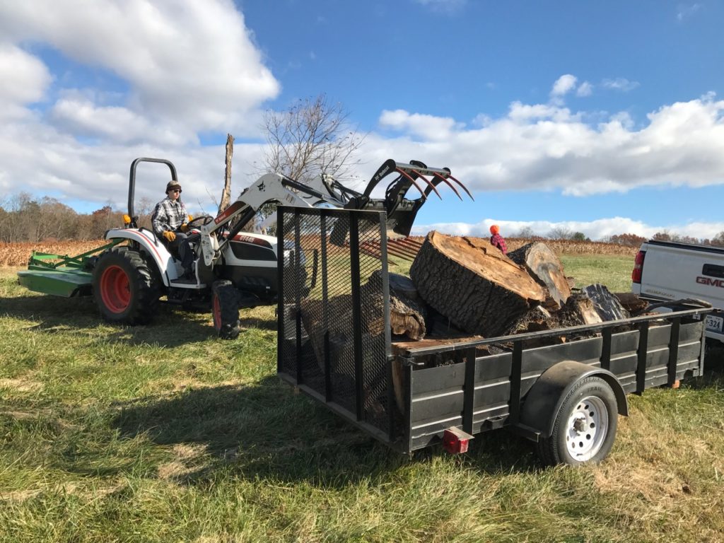 Patrick loading wood to be split